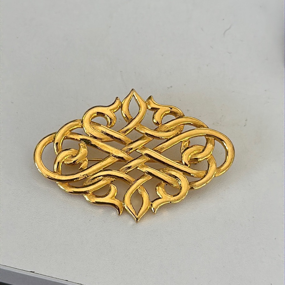 Gold tone broach